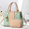 Detail of elegant two-piece handbag set featuring green stripe texture and a mini coin purse - Khaki and Green