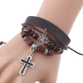 Handmade multilayer leather bracelet with wooden beads and silver cross pendants on wrist - Dark Brown