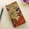 Top view of brown kraft notebook with vintage floral pattern and pencil on beige fabric - 90*170mm / Red