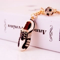 Golden football boot keychain with sparkling rhinestones and a small soccer ball pendant - Gold