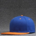 Flat brim baseball cap featuring a blue crown with a contrasting orange brim and top button - Orange Brim + Blue