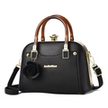 Elegant black lychee leather handbag with amber resin handles and rose pendant - Black
