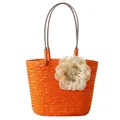 Handmade orange straw woven tote bag featuring a beige flower detail and brown handles - Orange