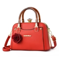 Elegant red leather handbag with amber resin handles and a rose charm accessory - Red