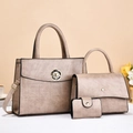 Detailed view of champagne leather handbag set with floral clasp and textured finish - Khaki