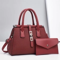 Detailed view of dark red pleated handbag with silver metal rings and matching envelope pouch - Red