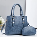 Detail view of navy blue faux leather tote bag with gold hardware and coin purse - Blue