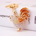 Golden rooster keychain with sparkling yellow and clear rhinestones on a metal finish - Gold
