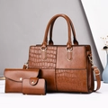 Detailed view of the three-piece brown tote bag set with crocodile skin texture and gold hardware - Handbag, Clutch and Card Holder / Earthy Yellow