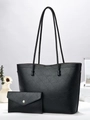 Macro shot of black geometric textured tote bag with matching envelope clutch and gold clasp - Black