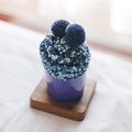 Blue and white coral fleece socks with pom-poms in a purple polka dot cup - One Size / Navy Blue & White
