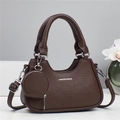 Detail of dark brown pebble leather tote bag with dual handles and round coin purse - Coffee