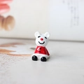 Vue macro d'une mignonne figurine de souris en céramique blanche avec habit de Noël rouge - Ours de Noël 22MM