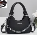 Detail of black pebbled leather crossbody bag with silver chain and crescent pendants - Black