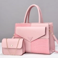 Detail of pink two-piece handbag set featuring textured fabric and gold chain strap - Pink