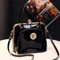 Elegant black patent leather handbag with gold cat logo and crystal lock detail - Black