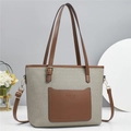 Detail of canvas bucket bag with brown leather trim and fashion lettering - Gray