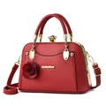 Elegant red pebbled leather handbag with gold frame and decorative rose pendant charm - Red