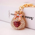 Portachiavi a sacchetto della fortuna dorato con strass a cuore rosa e fiocco - Viola