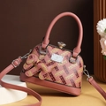 Dusty pink shell bag with H-letter print and sparkling ball lock displayed on a white base - Pink