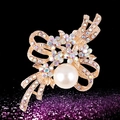 Elegant gold bow brooch with rainbow rhinestones and a large round faux pearl - xz4019 Hollow Bow