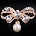 Elegant gold bow brooch with sparkling rhinestones and a dangling white pearl drop - xz4026 Bow Dangle