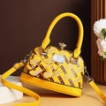 Bright yellow shell-shaped handbag with adjustable strap and rhinestone buckle - Yellow