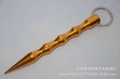 Macro detail of gold metal tactical kubotan keychain with non-slip grip for self-defense - Pointed Head Gold