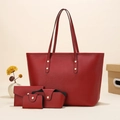 Detail of red pebbled leather tote bag set including wallet and case with gold studs - Red