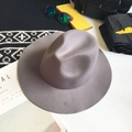 Classic grey wide brim wool fedora hat styled with fashion accessories on white surface - Gray