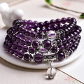 Elegant multi-layer purple glass bead bracelet with silver spacers on white ceramic tray - 108 Beads/6mm / 4-Layer Purple