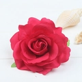 Macro shot of red silk rose hair clip petals with realistic texture on a white wooden background - Rose Red