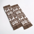 Close-up of brown knitted leg warmers featuring white reindeer and snowflake festive patterns - Vintage Khaki/White