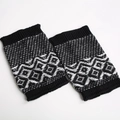 Detail of black and white geometric jacquard knit leg warmers with ribbed edges - Black/White