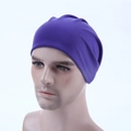 Detail view of a purple knitted dome beanie cap shown on a mannequin head model - Deep purple