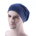 Close-up of a blue knitted beanie cap worn by a male model to show fit and texture - Navy Blue
