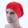 Close-up of bright red knitted slouchy beanie with soft texture on a male mannequin head - Red
