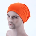Detail view of vibrant orange knitted slouchy beanie on male mannequin head for casual style - Orange