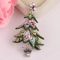 Close-up of a Christmas tree brooch with colorful rhinestones and green enamel on a floral background - Silver Multicolor Christmas Tree (BR1343)