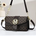 Brown monogram crossbody bag with gold M logo and chain strap on a minimalist background - Coffee