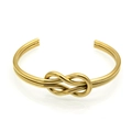 Detailed close-up of a gold-plated knot bangle with a polished metallic finish - Inner Diameter 60mm / Gold
