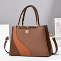 Fashionable women's two-tone handbag with textured weaving and gold butterfly charm - Brown