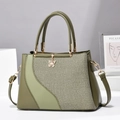 Green patchwork handbag with woven texture and gold butterfly pendant charm - Green