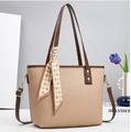 Detail of beige faux leather tote with textured finish, brown trim and silk scarf decor - Apricot