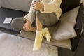 Close-up of cozy thickened coral fleece socks in cream and light yellow on a soft carpet - One Size / Solid Style Tender Yellow