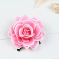Detail of pink artificial silk rose hair clip on a white wooden background with a seashell - White Edge Pink