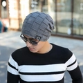 Detail of grey knitted beanie with star patch against a blurred outdoor city background - Gray (Fleece Lined)