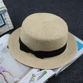 Elegant beige straw boater hat featuring a classic black ribbon bow on a textured surface - M / Flat Top Plain / Beige