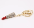 Detail of gold keychain with lipstick pendant featuring red enamel and clear rhinestones - Large / Red