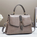 Elegant crocodile embossed top-handle handbag in taupe with gold buckle and adjustable strap - Gray